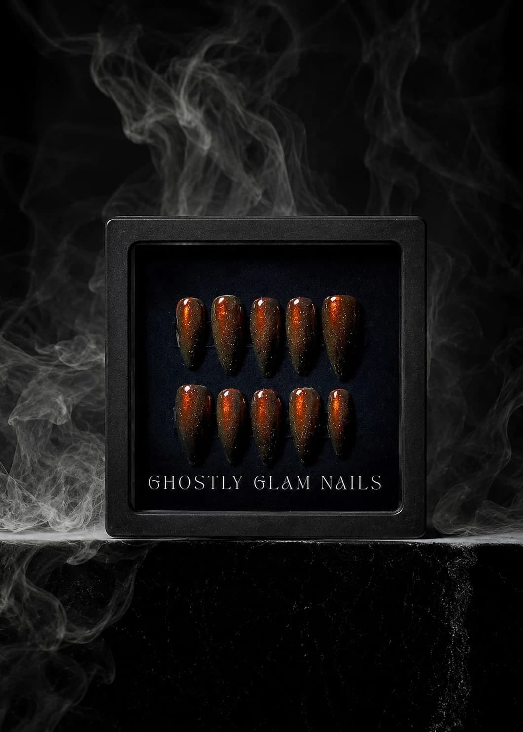Glossy red press-on nails worn on the hand.